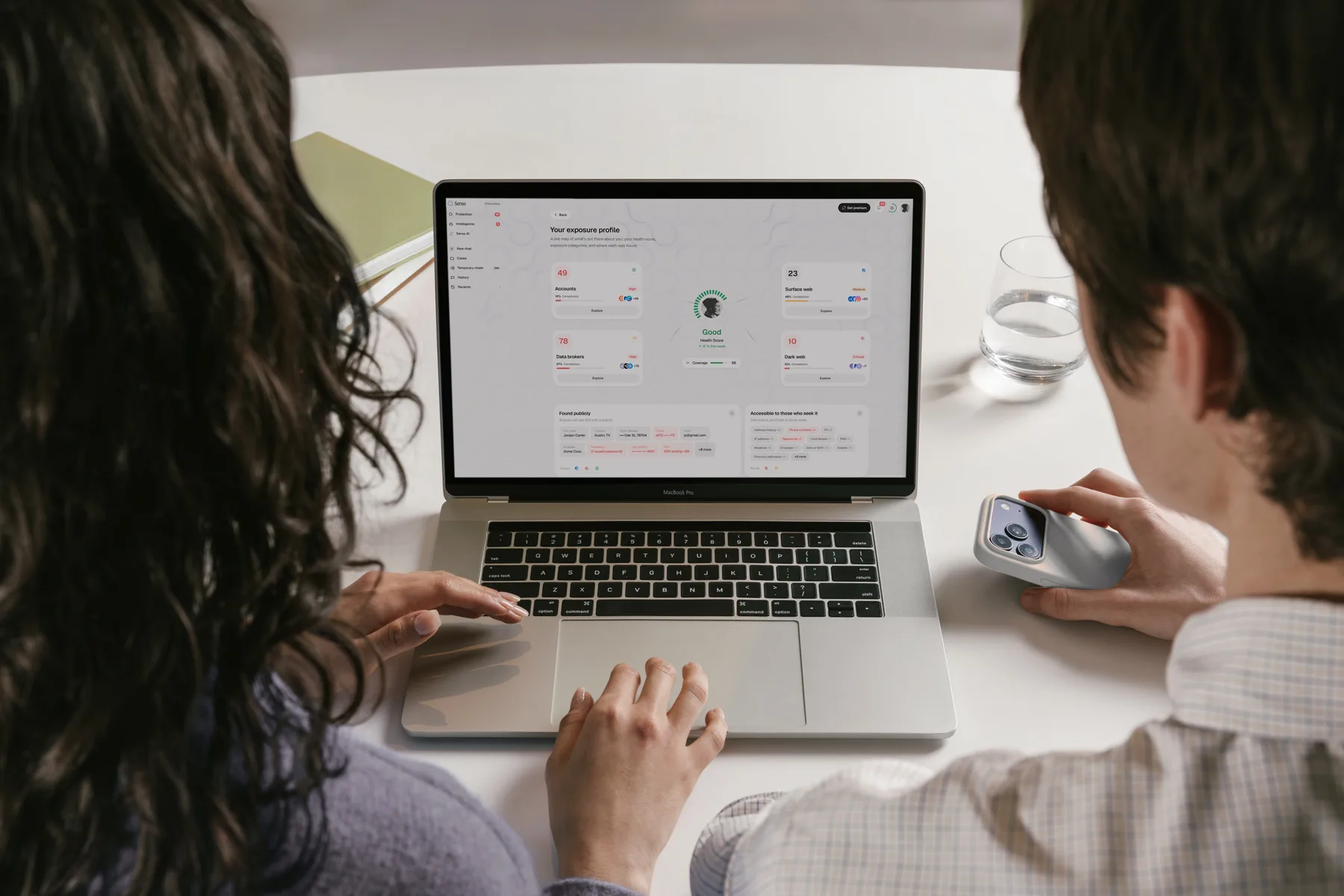 Two people reviewing an exposure profile in Serus on a laptop